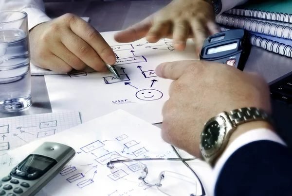 Hands sketching a site layout plan to decide where Oberleen air quality monitors should be placed